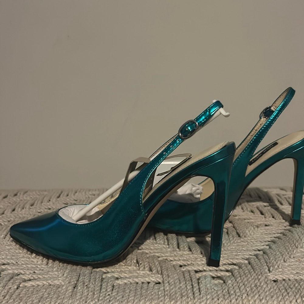 7 medium metallic blue sling backs. Never worn